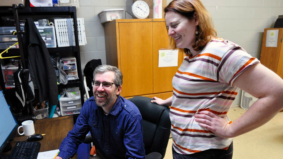 Two EMOW employees smiling in their office