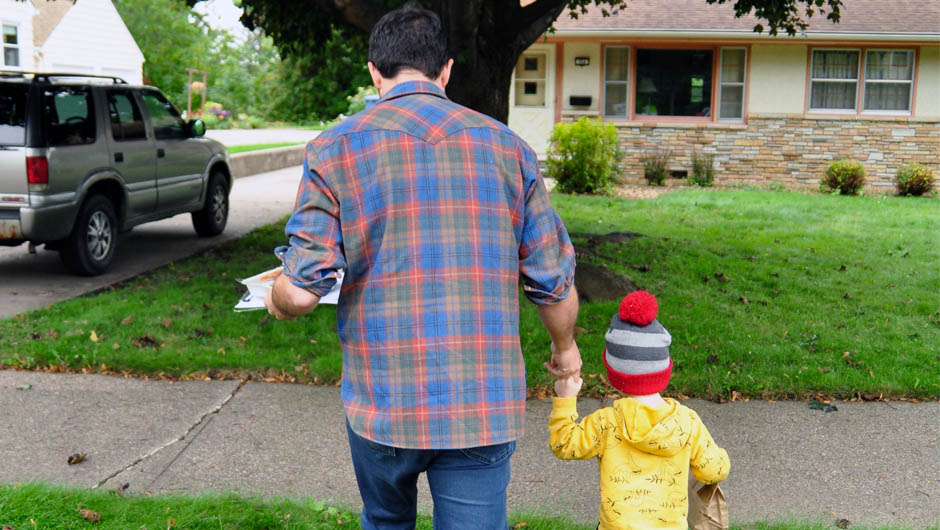 Parent and child volunteers walking to client house